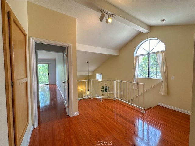 interior space with vaulted ceiling with beams and hardwood / wood-style flooring