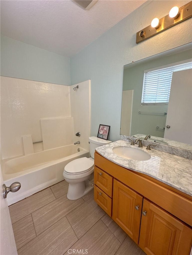 full bathroom with shower / bathing tub combination, vanity, and toilet