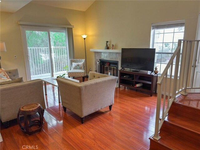 13168 Pinnacle Ct, Chino Hills, CA 91709 - living room featuring wood finished floors, a fireplace, and vaulted ceiling