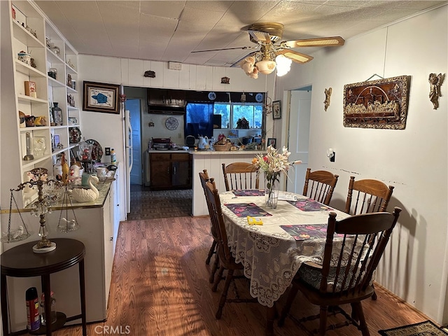 dining space featuring ceiling fan and dark hardwood / wood-style flooring