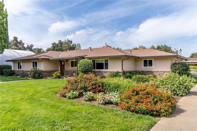 ranch-style house featuring a front lawn