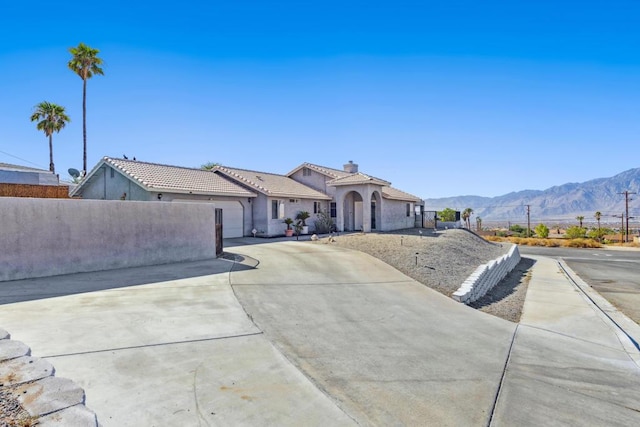 ranch-style house with a mountain view and a garage