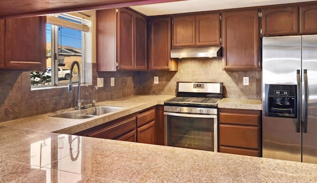 kitchen featuring sink, appliances with stainless steel finishes, and tasteful backsplash