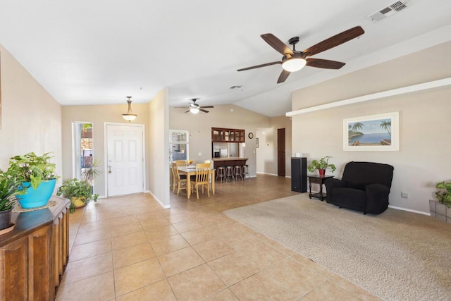 interior space featuring light tile patterned floors, ceiling fan, and lofted ceiling