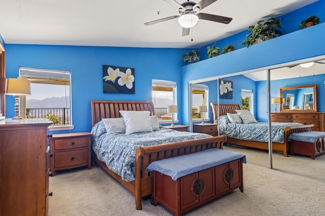 carpeted bedroom featuring ceiling fan, lofted ceiling, and a closet