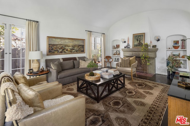 living room featuring dark hardwood / wood-style flooring and lofted ceiling