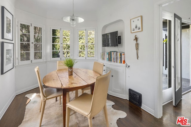 dining space featuring dark wood-type flooring