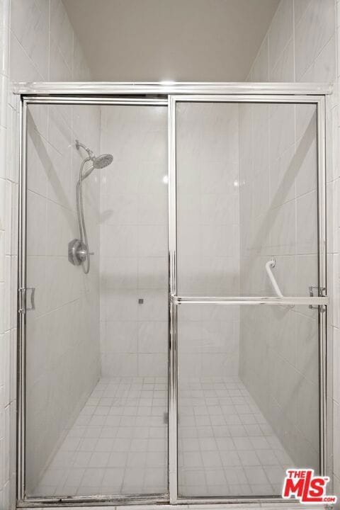 bathroom featuring a shower with door