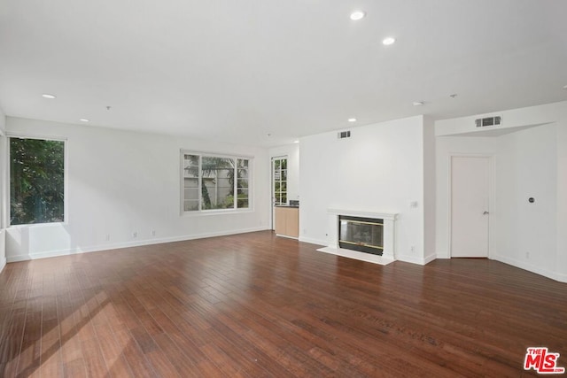 unfurnished living room featuring dark hardwood / wood-style flooring