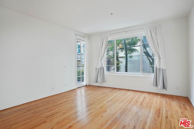 unfurnished room featuring light hardwood / wood-style floors