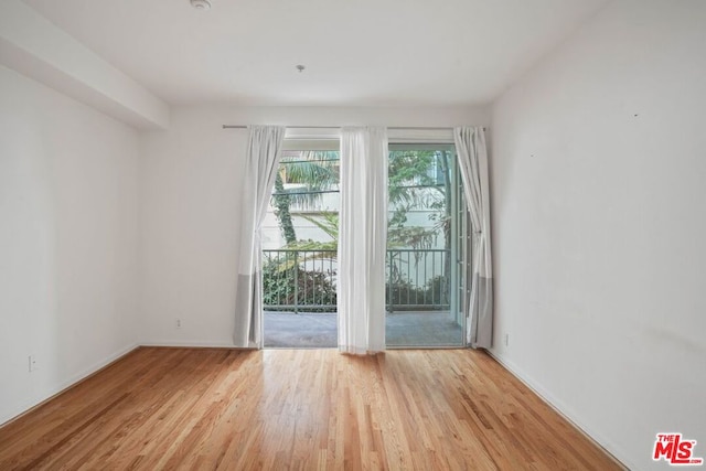 unfurnished room with light hardwood / wood-style floors