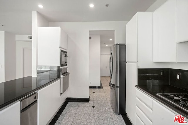 kitchen with white cabinets and appliances with stainless steel finishes