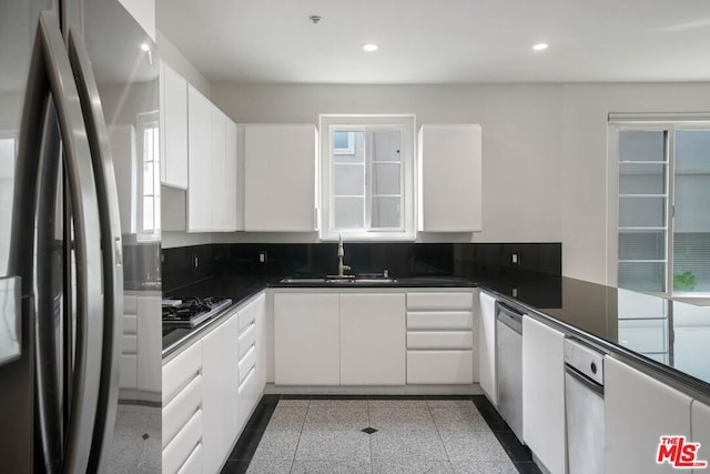 kitchen with sink, white cabinetry, and stainless steel appliances