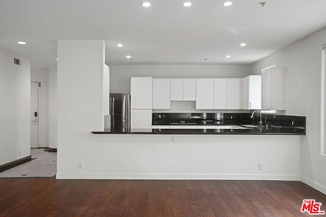 kitchen featuring white cabinetry and dark wood-type flooring