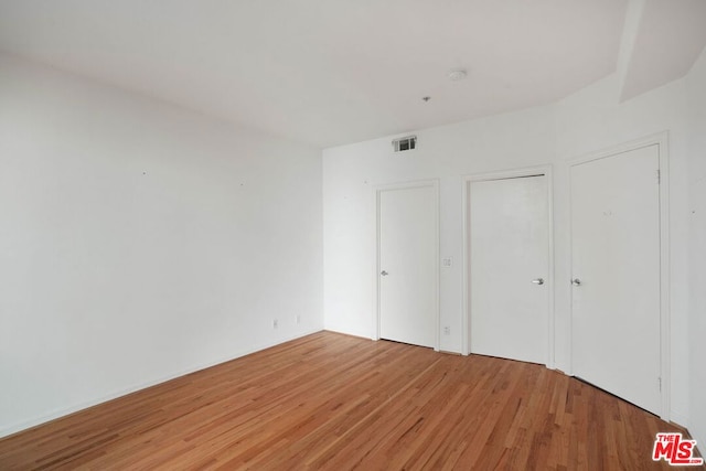 unfurnished bedroom featuring hardwood / wood-style flooring