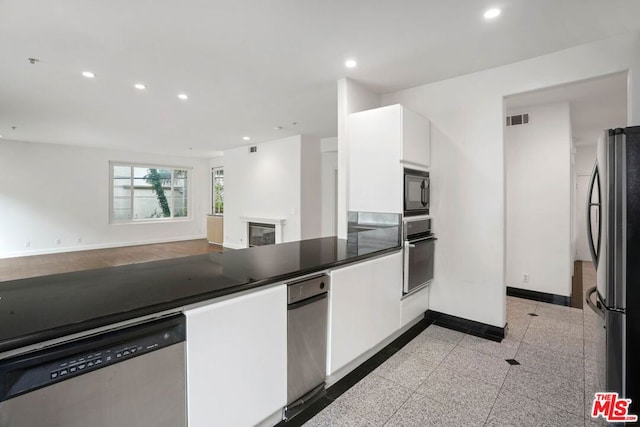 kitchen featuring white cabinets and appliances with stainless steel finishes