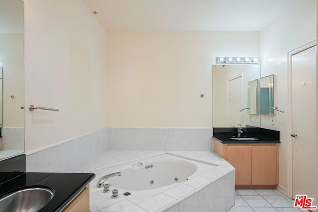 bathroom with tiled bath and vanity