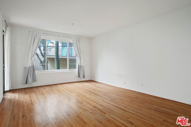 unfurnished room with hardwood / wood-style floors