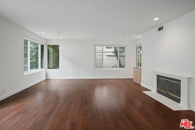 unfurnished living room with dark hardwood / wood-style flooring