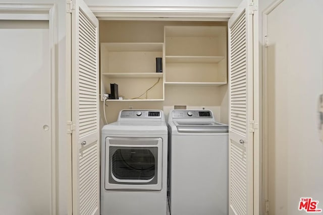 clothes washing area featuring washer and clothes dryer