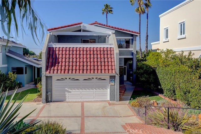 view of front of property with a balcony and a garage