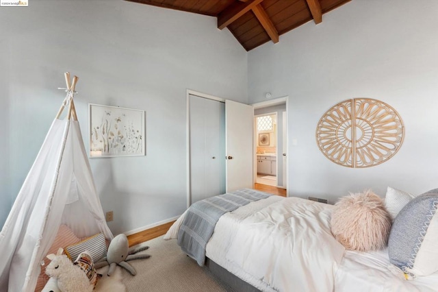 bedroom featuring wooden ceiling, beamed ceiling, high vaulted ceiling, wood-type flooring, and a closet