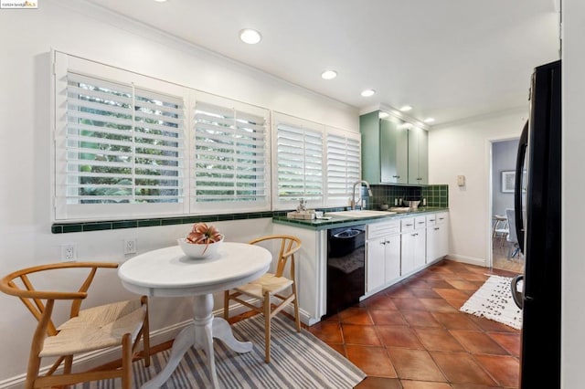 kitchen featuring decorative backsplash, a wealth of natural light, white cabinets, and black appliances