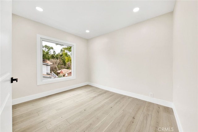 empty room with light hardwood / wood-style flooring