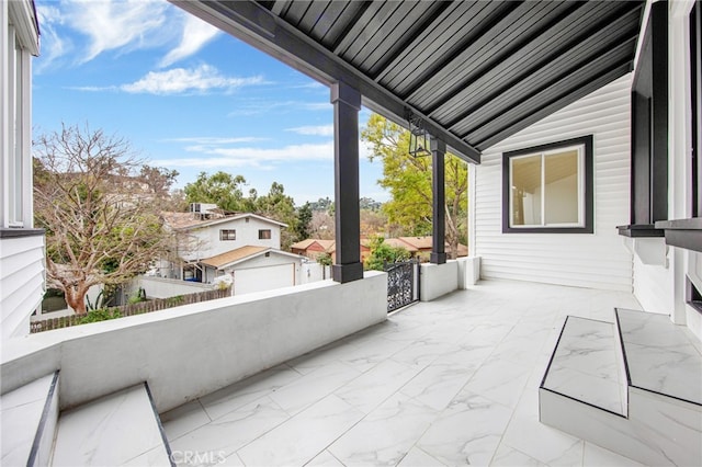 view of patio featuring an outbuilding and a garage