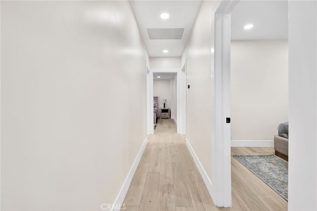 corridor with light hardwood / wood-style flooring