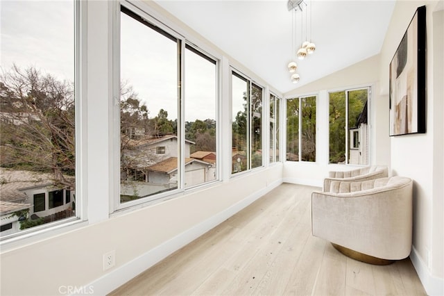 sunroom featuring vaulted ceiling