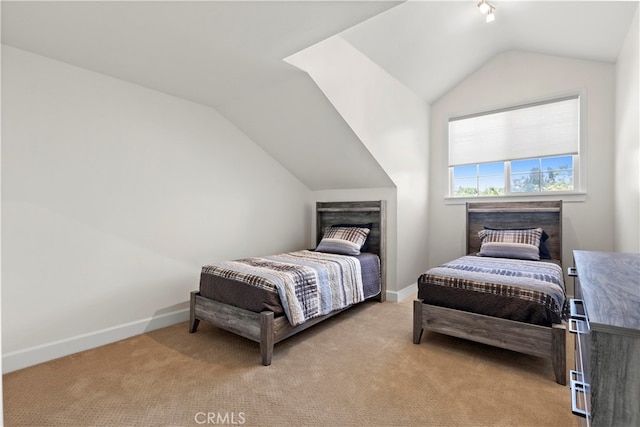 bedroom with light carpet and lofted ceiling