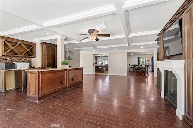 kitchen featuring ceiling fan, a center island, dark hardwood / wood-style flooring, coffered ceiling, and beam ceiling