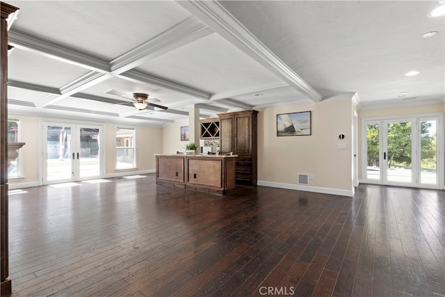 unfurnished living room featuring dark wood-type flooring, ceiling fan, french doors, and a healthy amount of sunlight