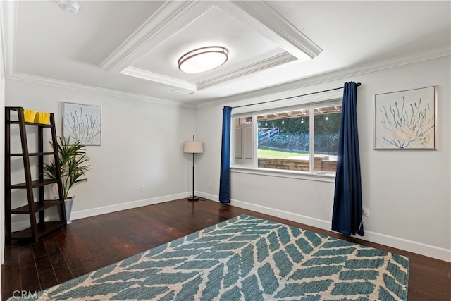 interior space with ornamental molding, a tray ceiling, and dark wood-type flooring