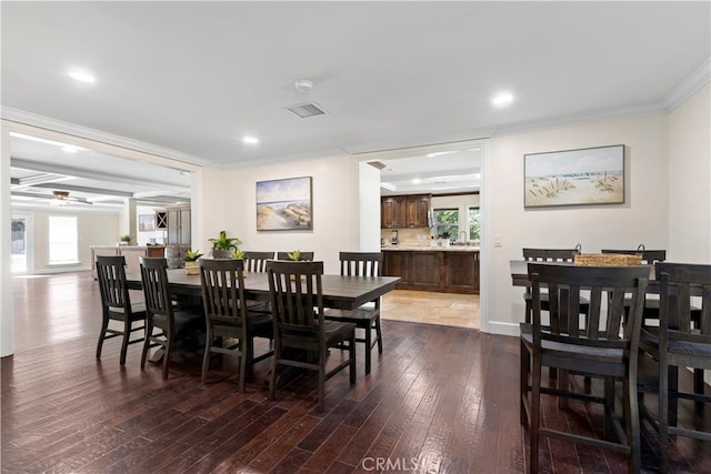 dining area with ceiling fan, ornamental molding, plenty of natural light, and dark hardwood / wood-style floors