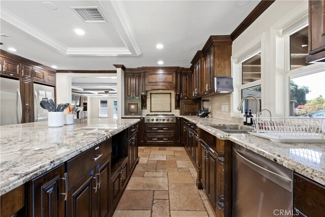 kitchen with dark brown cabinetry, stainless steel appliances, crown molding, and tasteful backsplash