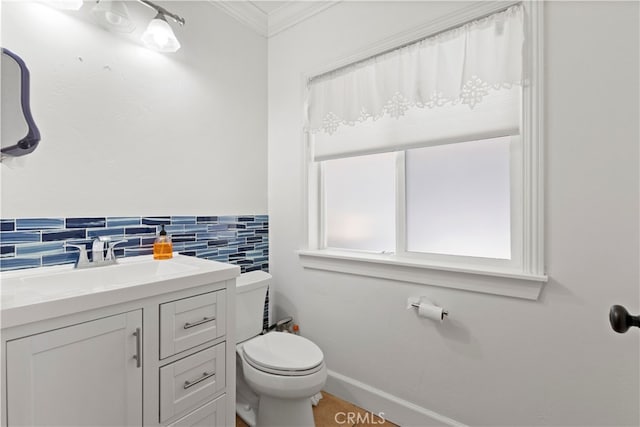 bathroom with ornamental molding, vanity, toilet, and decorative backsplash