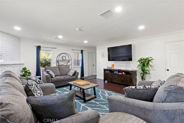 living room featuring a fireplace, dark hardwood / wood-style floors, and ornamental molding