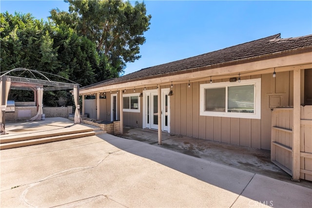 view of front facade with french doors and a patio area