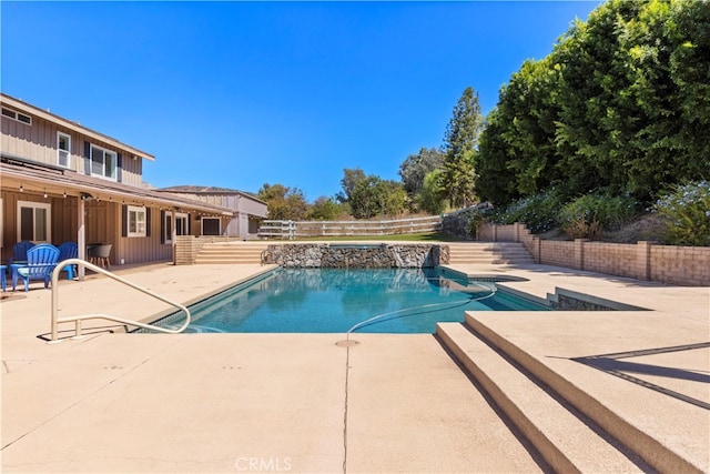 view of swimming pool with a patio