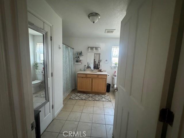 bathroom with tile patterned floors, vanity, toilet, and a shower with curtain