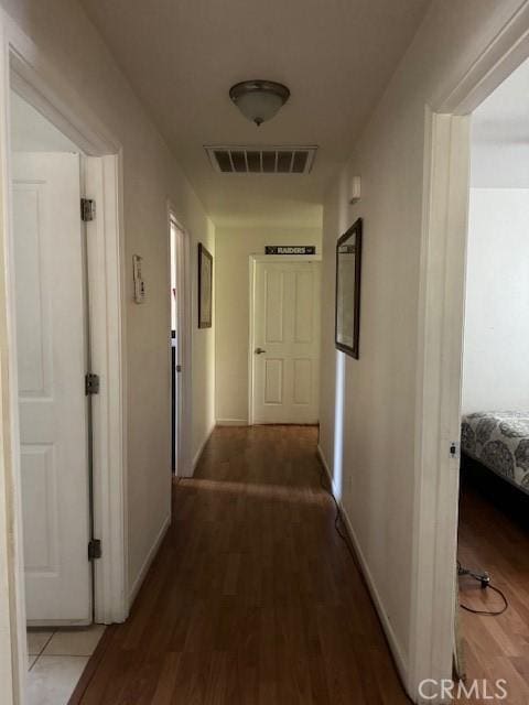 hall with dark wood-type flooring