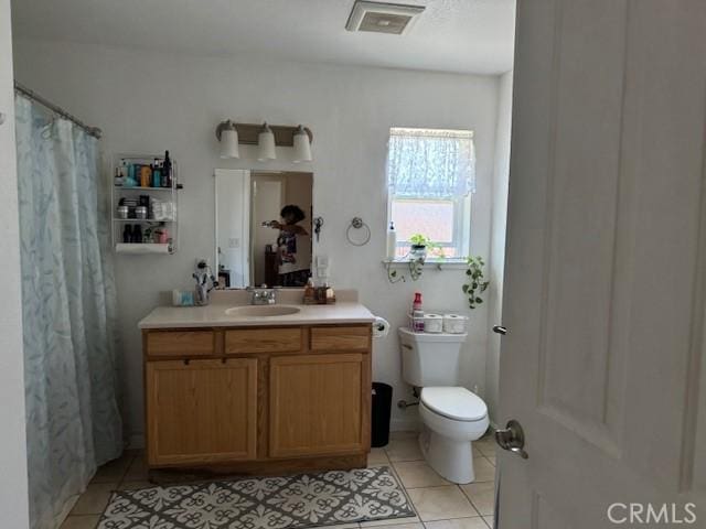 bathroom with tile patterned floors, vanity, and toilet