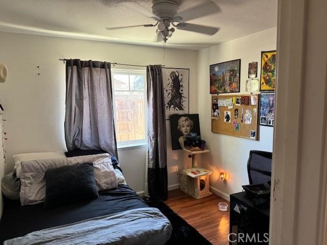 bedroom with ceiling fan and hardwood / wood-style floors