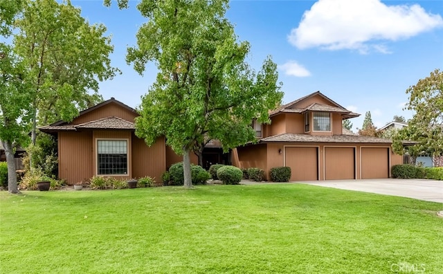 view of front of home featuring a garage and a front yard