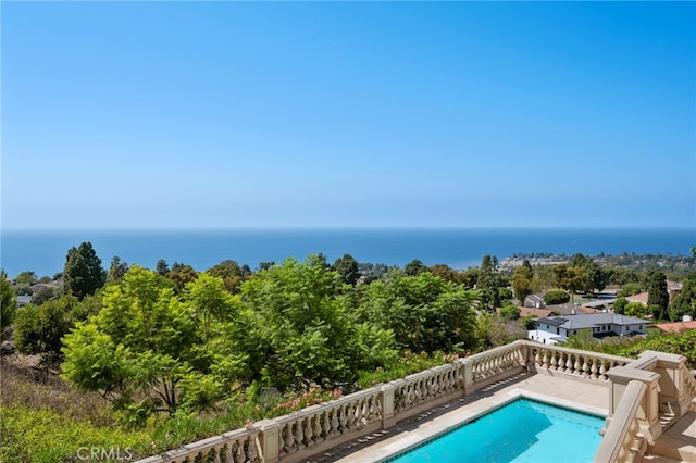 view of swimming pool featuring a water view