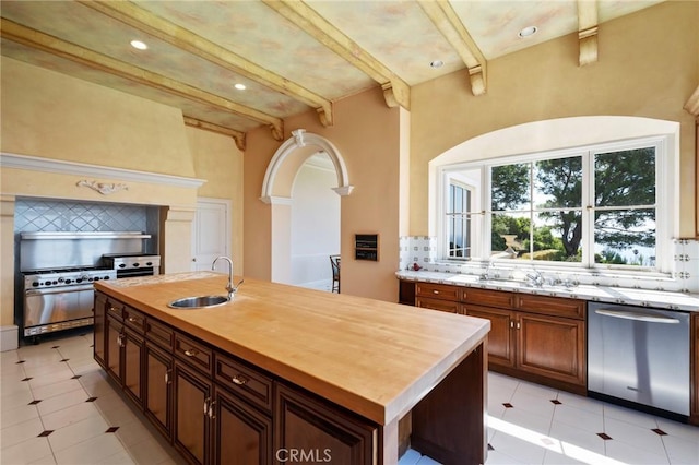 2736 Via Victoria, Palos Verdes Estates, CA 90274 - kitchen with backsplash, a center island with sink, a sink, and stainless steel appliances