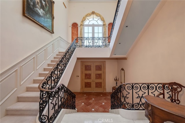 stairs featuring a high ceiling