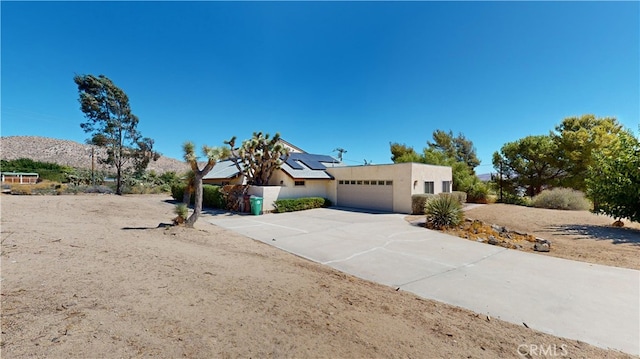 pueblo-style house with a mountain view and a garage